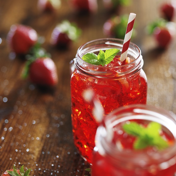 old fashioned jars with vivid red strawberry cocktail